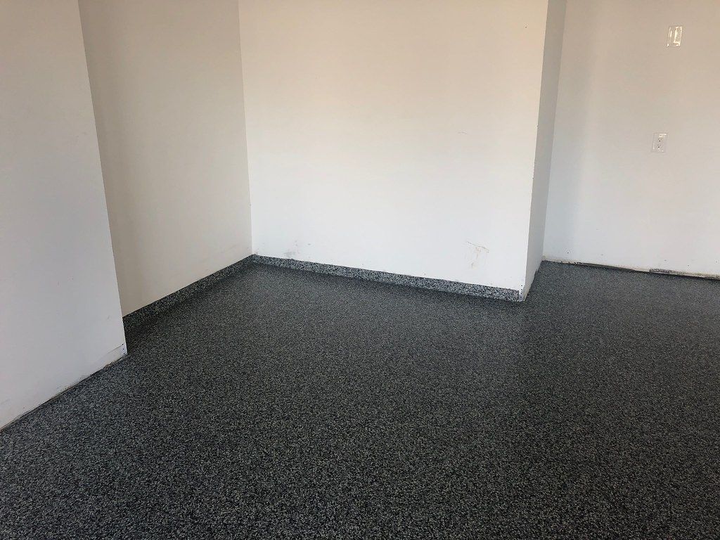 Decorative flake epoxy flooring system with grey and white chips for Sioux Falls garages