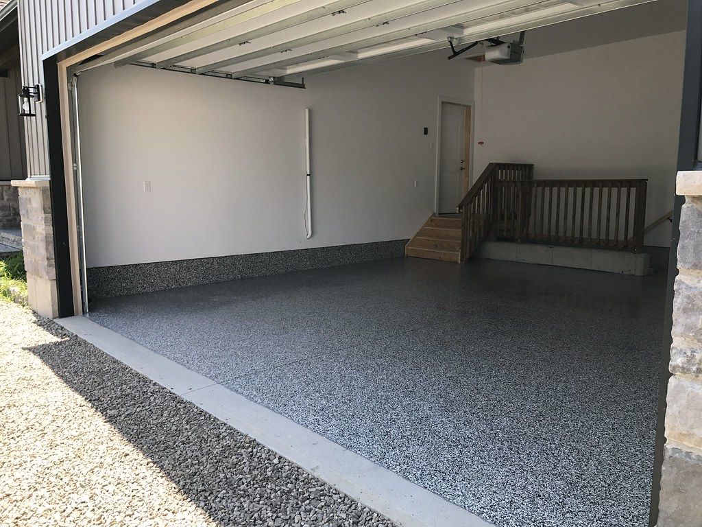 Finished grey flake epoxy garage floor in Sioux Falls with glossy protective topcoat